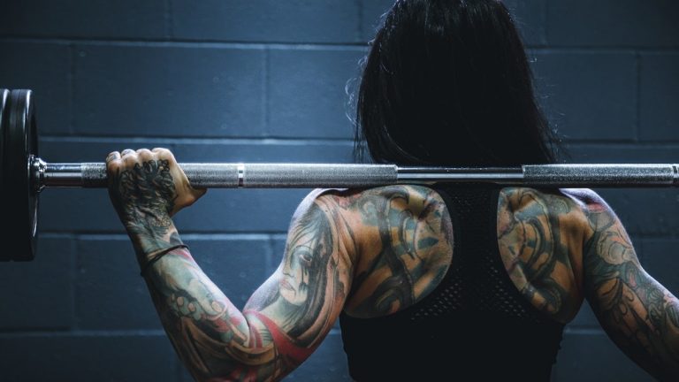 woman carrying barbell