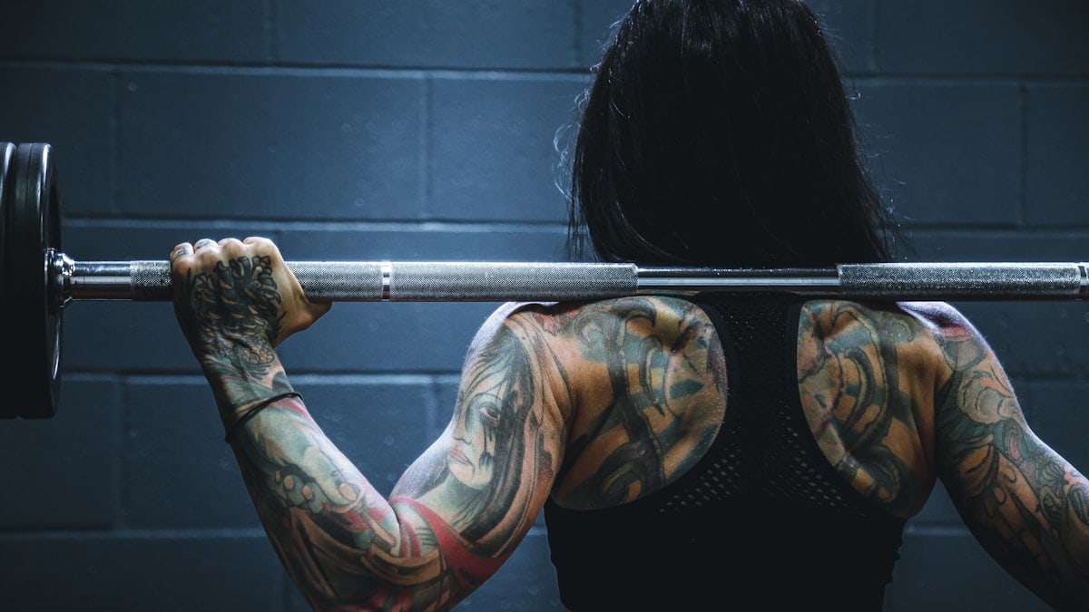 woman carrying barbell